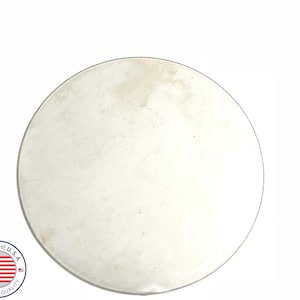 May include: A plain, round, silver metal disc.