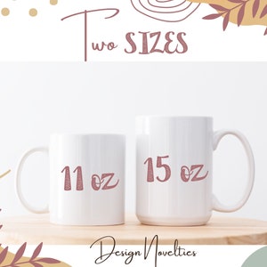 two white coffee mugs with red numbers on them