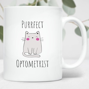 May include: White ceramic mug with a black and white illustration of a cat with pink cheeks. The text "Purrfect Optometrist" is printed on the mug.