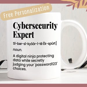 May include: White ceramic mug with a black design that reads "Cybersecurity Expert" and defines the term as a "digital ninja protecting data while secretly judging your 'password123' choices."