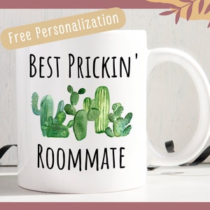a white coffee mug with a green cactus on it