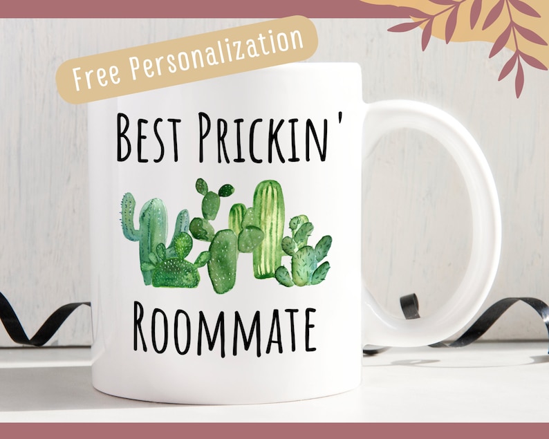a white coffee mug with a green cactus on it