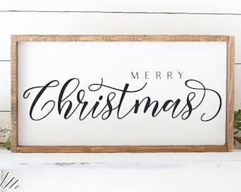 May include: A rectangular wooden sign with a white background and the black text Merry Christmas in a cursive script. The sign features a natural wood frame. Below the sign, text reads Ivan & Co. DESIGNS and SVG - DXF - EPS - PNG - PDF.