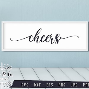 May include: White framed sign with the word "cheers" written in black cursive script.