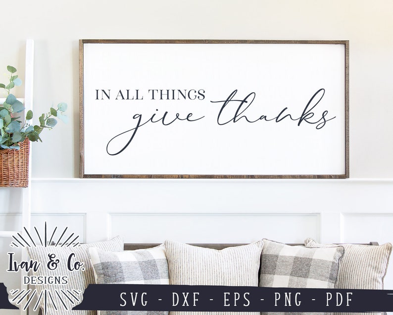 May include: A white wooden sign with a brown frame, featuring the text "IN ALL THINGS give thanks" in black cursive font.