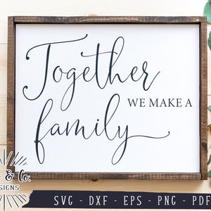 May include: A wooden sign with the text "Together we make a family" in a cursive font. The sign is on a white background and has a brown wooden frame.