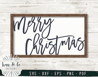 May include: A wooden framed sign with the text "Merry Christmas" written in a cursive font in dark blue.