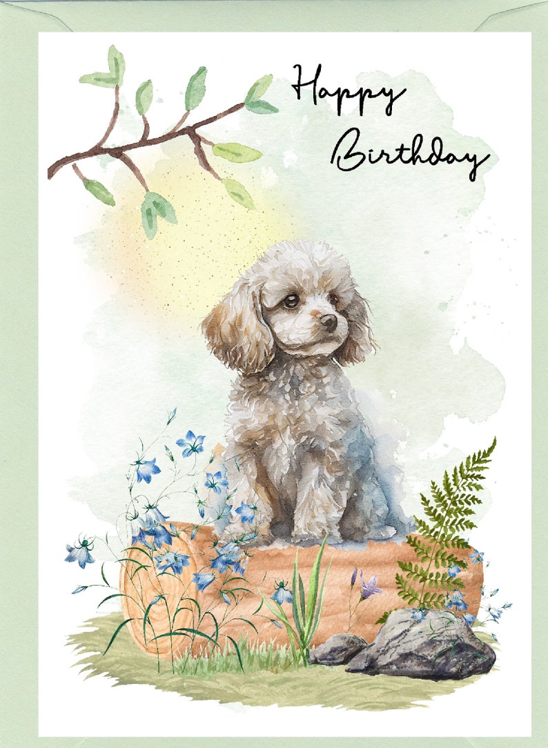 May include: A watercolour illustration of a white poodle sitting on a log with blue flowers and green ferns. The text "Happy Birthday" is written in black cursive at the top of the image.