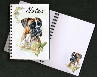 May include: Spiral-bound notebook with a watercolor illustration of a Boxer dog. The cover features the word "Notes" in black script, a Boxer portrait, and floral accents. A second notebook page is visible.