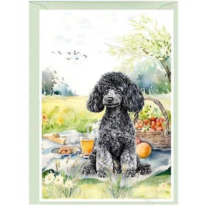 May include: Watercolor art print of a black poodle sitting on a picnic blanket. A basket of fruit, a glass of amber liquid, and a loaf of bread are on the blanket. The background shows a sunny field and trees.