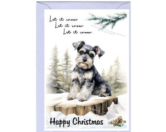 May include: A Christmas card featuring a Schnauzer dog sitting on a snowy tree stump in a winter scene. The card has the text "Let it snow" and "Happy Christmas" in black font.