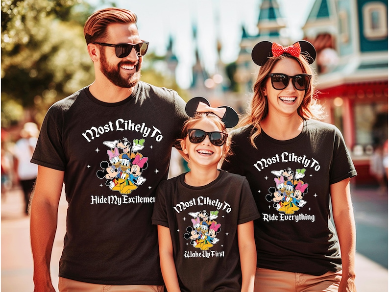 May include: Black t-shirts with Disney characters and the text "Most Likely To." One shirt says "Hide My Excitement," another says "Ride Everything," and the third says "Wake Up First."