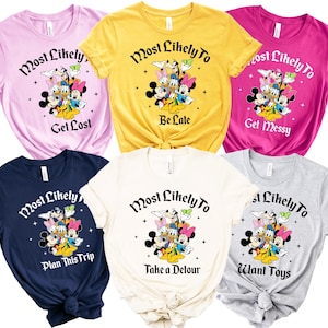 May include: A collection of t-shirts in various colors, including pink, yellow, navy, white, and gray. Each shirt features a graphic of Disney characters and the phrase "Most Likely To" followed by a different action, such as "Get Lost" or "Want Toys."
