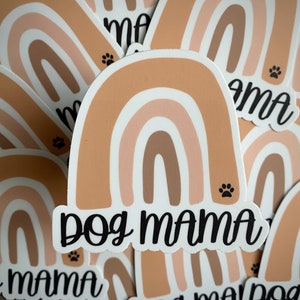 May include: A set of rainbow-colored stickers with the text "Dog Mama" in black lettering. The stickers feature a paw print design.