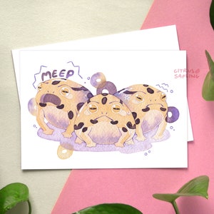 May include: A watercolor illustration of three cartoon frogs with black spots and yellow bellies. The frogs are on a purple background with white dots. The text "MEEP!" is above the frogs.