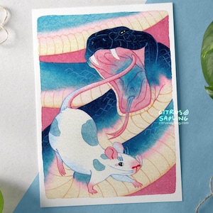 May include: A watercolour illustration featuring a dark blue snake with an open mouth, facing a white mouse with blue spots. The background has pink, blue, and yellow hues. The mouse has a pink nose and ears. The text "Citrus Sapling" is in the lower right corner.