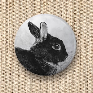 Puede incluir: Un dibujo en blanco y negro de un conejo con la cabeza girada hacia un lado. El conejo tiene orejas grandes y una cola esponjosa.