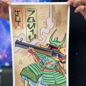 May include: A digital illustration of a Star Wars character, Boba Fett, dressed as a Japanese samurai warrior. He is holding a blaster rifle and has a green and red samurai armor. The background is a tan parchment with Japanese characters that read "Samurai" and "Fett".