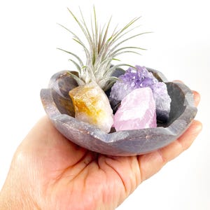 May include: A rustic wooden sign with the text "Welcome to our home" in white lettering. The sign features a distressed finish and a simple, inviting design, perfect for a front porch or entryway.