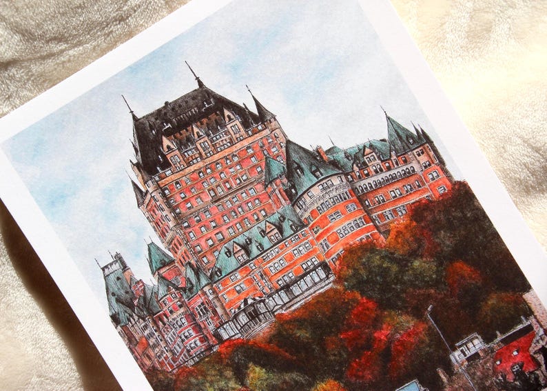 May include: Watercolor print of a large, ornate building with a red brick facade, green rooftops, and black turrets. The artwork depicts the building set against a light blue sky, with autumn foliage in the foreground.