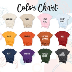 May include: Color chart showing 18 different t-shirt colors. The colors are: White, Natural, Sand, Light Pink, Light Blue, Sport Grey, Daisy, Gold, Orange, Antique Orange, Red, Maroon, Royal Blue, Navy, Purple, Forest Green, Dark Heather, and Black.