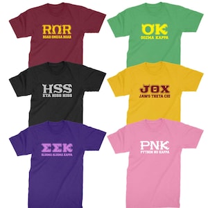 May include: Six different t-shirts with various colors and designs. Each shirt features a different acronym and text. The shirts are maroon, green, black, yellow, purple, and pink.