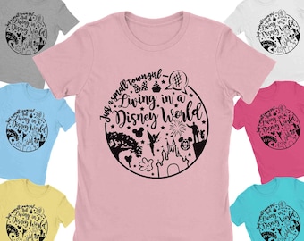 May include: A pink t-shirt with a black graphic design of a circle with the text "Just a small town girl - Living in a Disney World" and various Disney icons inside the circle.