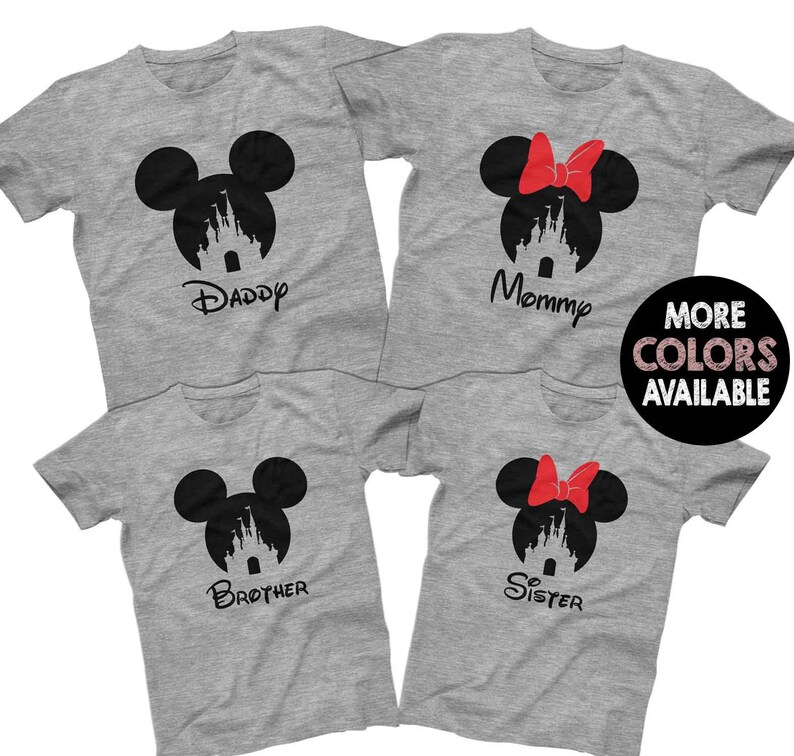 May include: Four grey t-shirts with a black silhouette of Mickey Mouse's head with the Disney castle inside. Each shirt has a different word printed below the silhouette: "Daddy", "Mommy", "Brother", and "Sister".