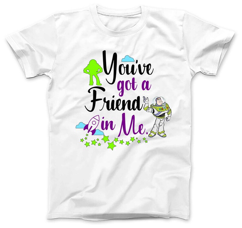 May include: White t-shirt with a green alien and a cartoon of Buzz Lightyear from Toy Story. The text on the shirt reads "You've got a friend in me."