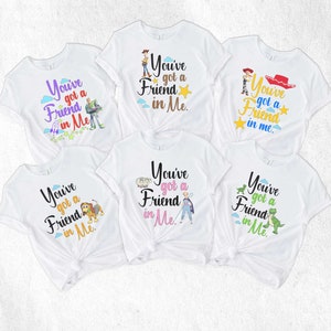May include: Five white t-shirts with different Toy Story characters and the text "You've got a Friend in Me."