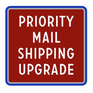 May include: A square sign with a maroon background and white text that reads "PRIORITY MAIL SHIPPING UPGRADE". The sign has a blue border and a white border.