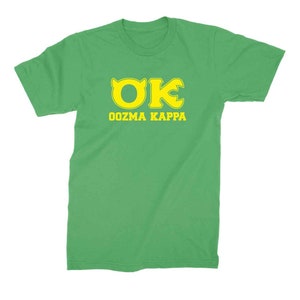 Peut inclure: Un t-shirt vert avec un logo "OK" jaune et le texte "OOZMA KAPPA" imprim&eacute; sur le devant.
