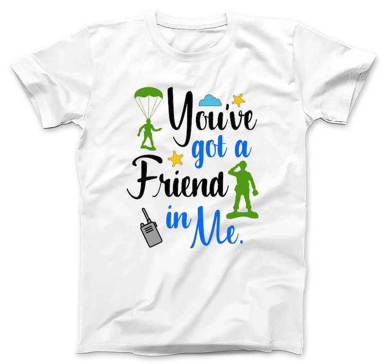 May include: White t-shirt with a green paratrooper, a blue cloud, a yellow star, and green army man graphic. The text on the shirt reads "You've got a Friend in Me."