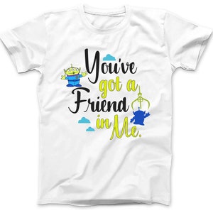 May include: White t-shirt with a green alien character and the text "You've got a friend in me."