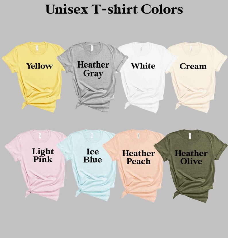 May include: A selection of unisex t-shirts in various colors, including yellow, heather gray, white, cream, light pink, ice blue, heather peach, and heather olive. The shirts are laid out flat on a gray background.