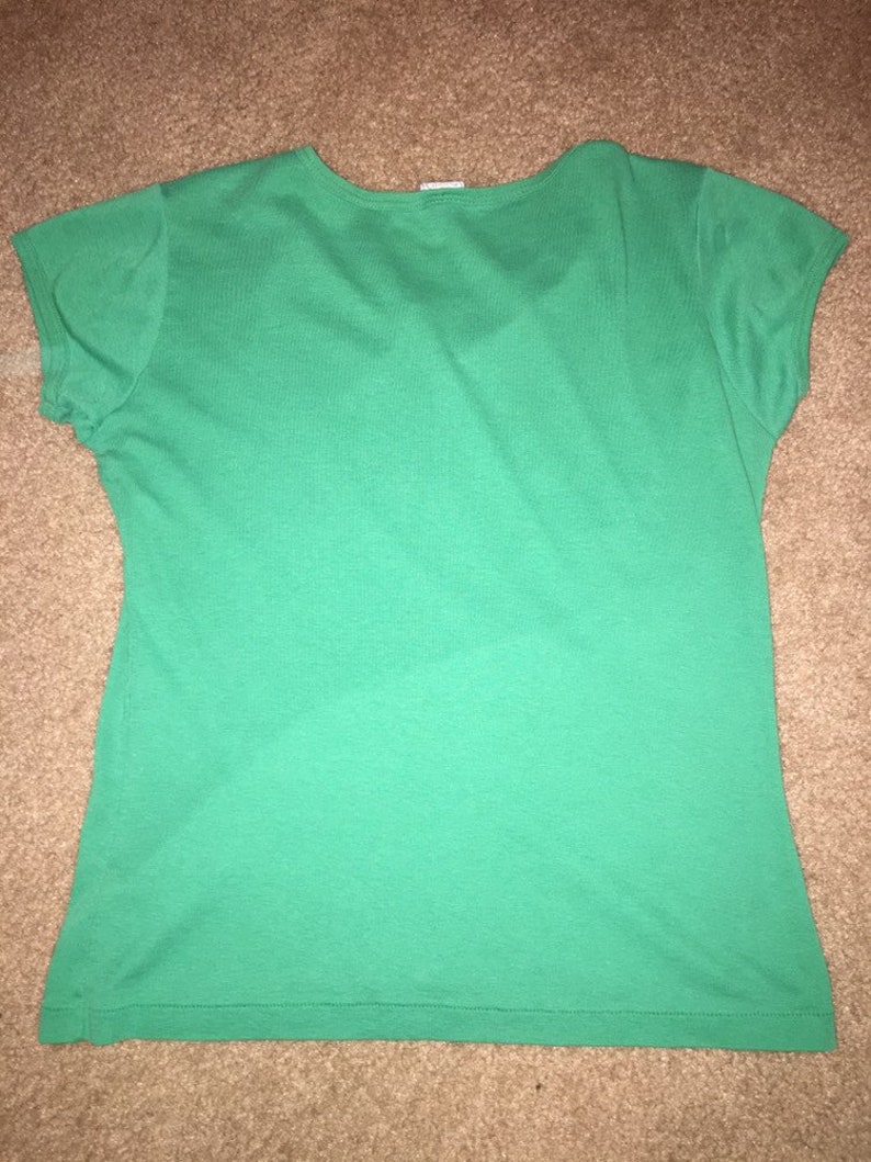 May include: A solid green short-sleeved t-shirt with a v-neck.