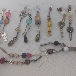 May include: Assortment of handmade earrings featuring various materials, colors, and designs.  The earrings include beads, charms, and metal accents.