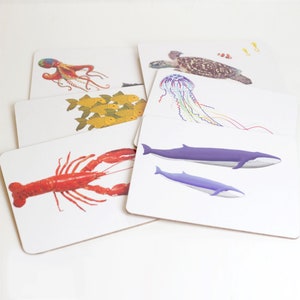 Set of Underwater animal mealmine and cork placemats including an Octopus, Blue Whale, Jellyfish, Goldfish, Lobster and Turtle