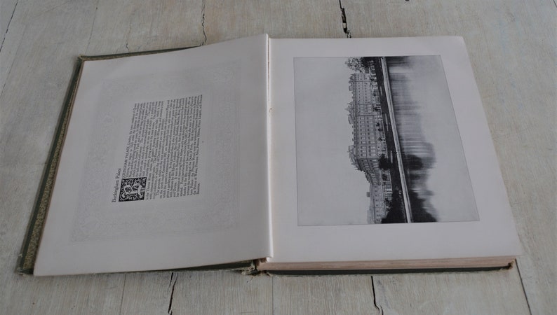 Op de afbeelding: Een open boek met een zwart-witfoto van een stadsgezicht en een rivier. De linkerpagina bevat tekst en een kleine zwart-witte illustratie.