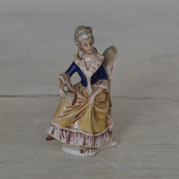 Antique German figurine of a sitting youg woman in 18th century style