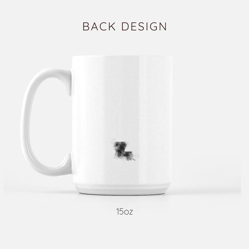 May include: White ceramic mug with a black outline of the state of Louisiana. The mug is 15 ounces.