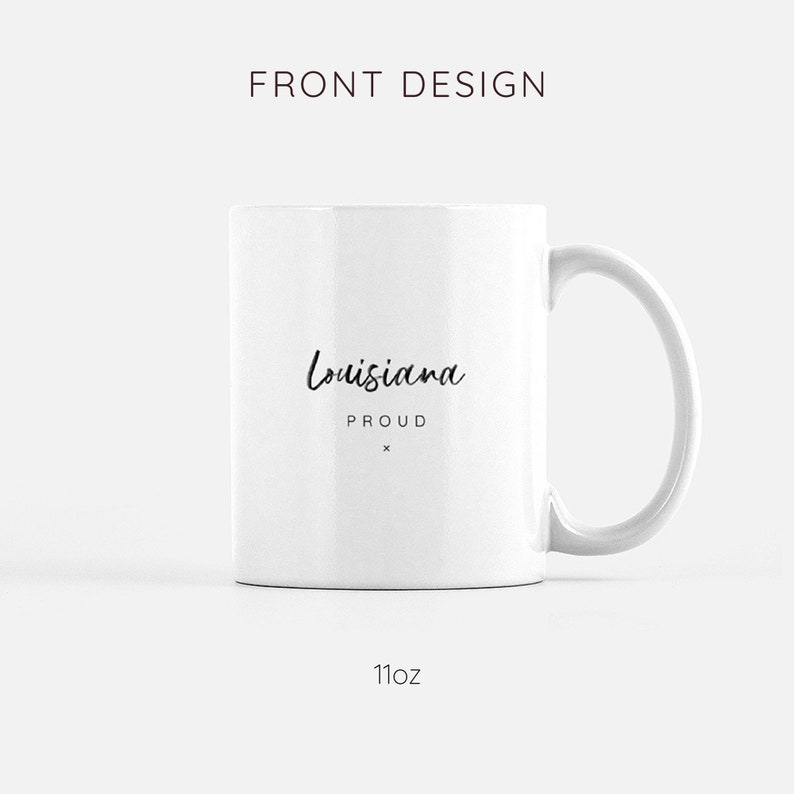 May include: White ceramic mug with a black handwritten design that says "Louisiana Proud" on the front. The mug is 11 ounces.