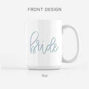 May include: White ceramic mug with a light blue cursive inscription that reads "bride". The mug is 15 ounces.