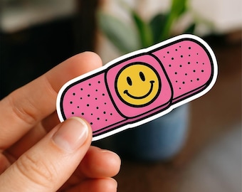 Cute Pink Bandage Sticker with Smiley Face – Funny Bandaid Vinyl Sticker – Cheerful Waterproof Decal for Laptops, Journals & More