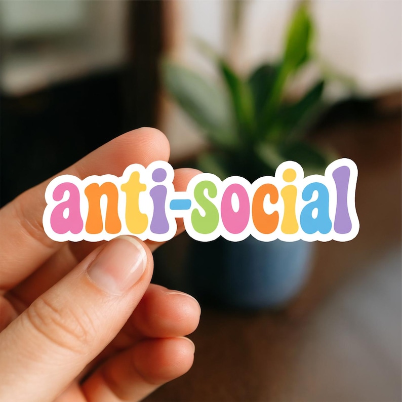 K&ouml;nnte beinhalten: Ein gestanzter Vinyl-Aufkleber mit dem Wort anti-social in einer verspielten, abgerundeten Schriftart. Jeder Buchstabe ist in einer anderen Farbe aus einer lebendigen Palette von Pink, Orange, Gelb, Lila, Gr&uuml;n und Blau gehalten und mit einem wei&szlig;en Rand versehen.