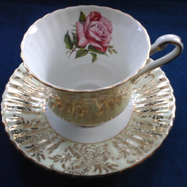 Paragon teacup and saucer duo pink cabbage rose abundant gold lace decorations pale yellow background England single warrant