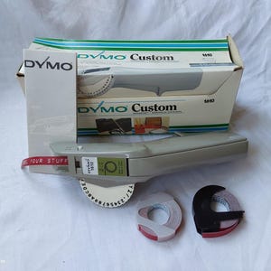 Vintage 1980s Dymo 1610 tapewriter embossed label maker in original box with instructions and 2 rolls of red tape works well