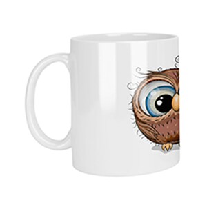 Könnte beinhalten: Eine weiße Keramiktasse mit einer Cartoon-Eulen-Illustration. Die Eule hat braune Federn, große blaue Augen und einen gelben Schnabel.
