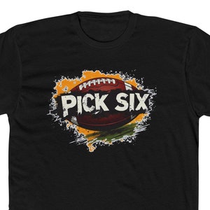 May include: Black t-shirt with a graphic of a football in a yellow and orange splatter design. The text "PICK SIX" is written in white on the football.