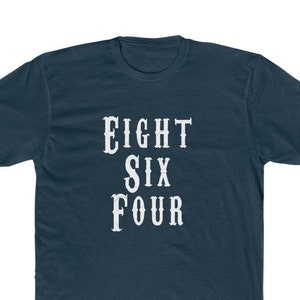 May include: A dark blue t-shirt with white text that reads "EIGHT SIX FOUR".